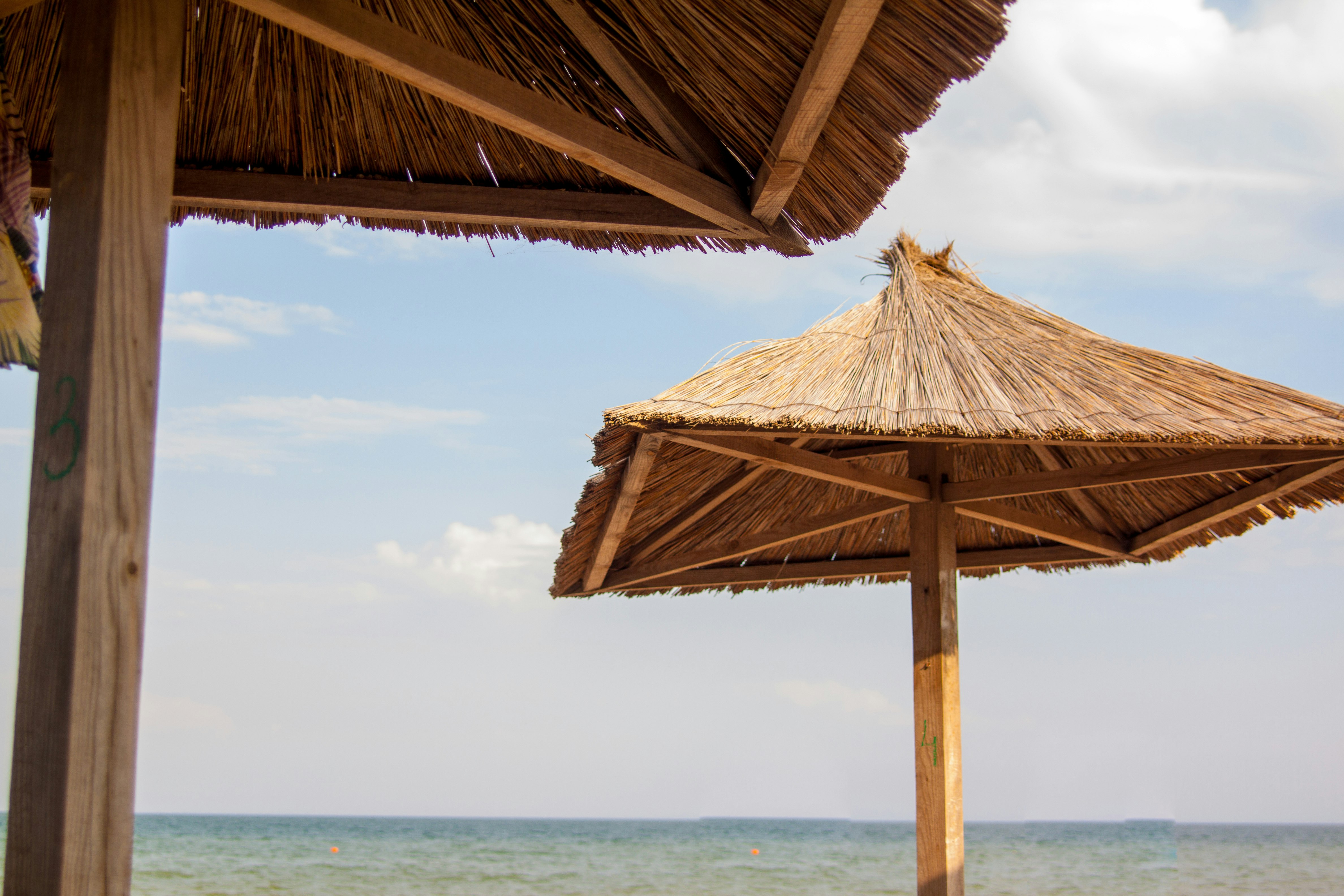 brown wooden roof on sea during daytime